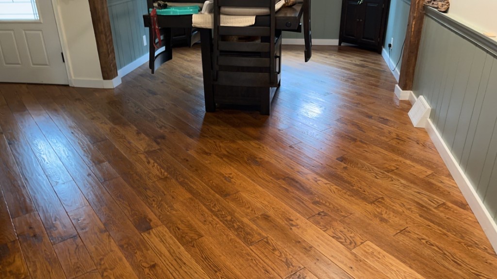 Wood flooring around a dining table after a floor care visit
