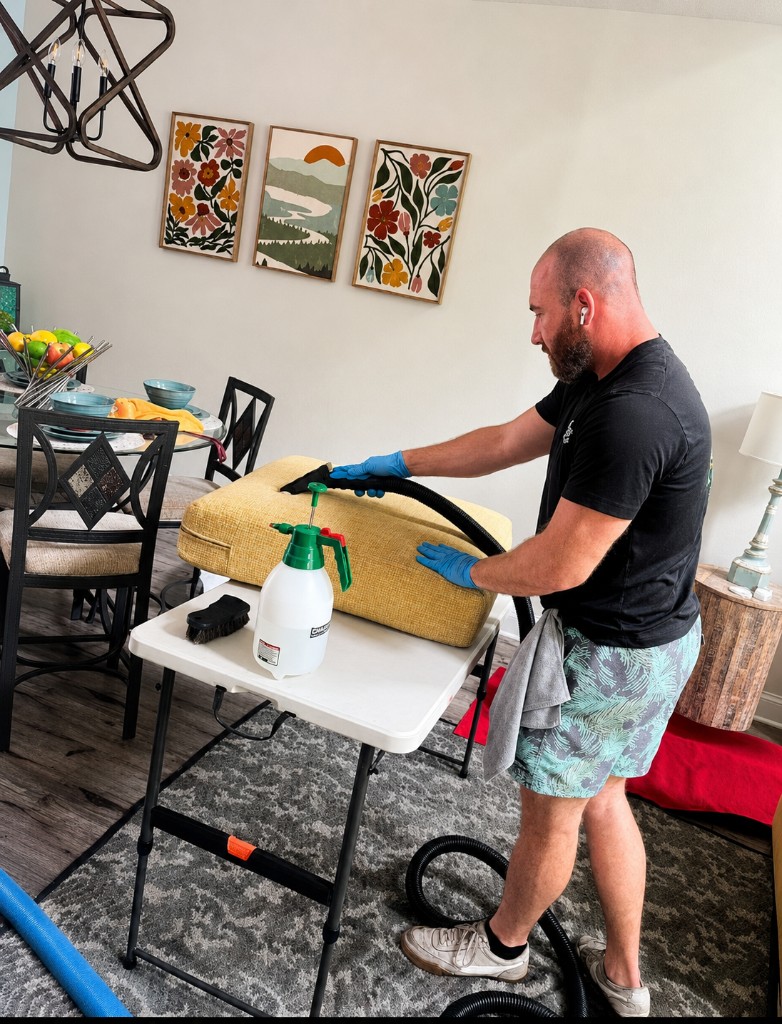 Eco-Dry technician cleaning upholstered furniture with floor protection